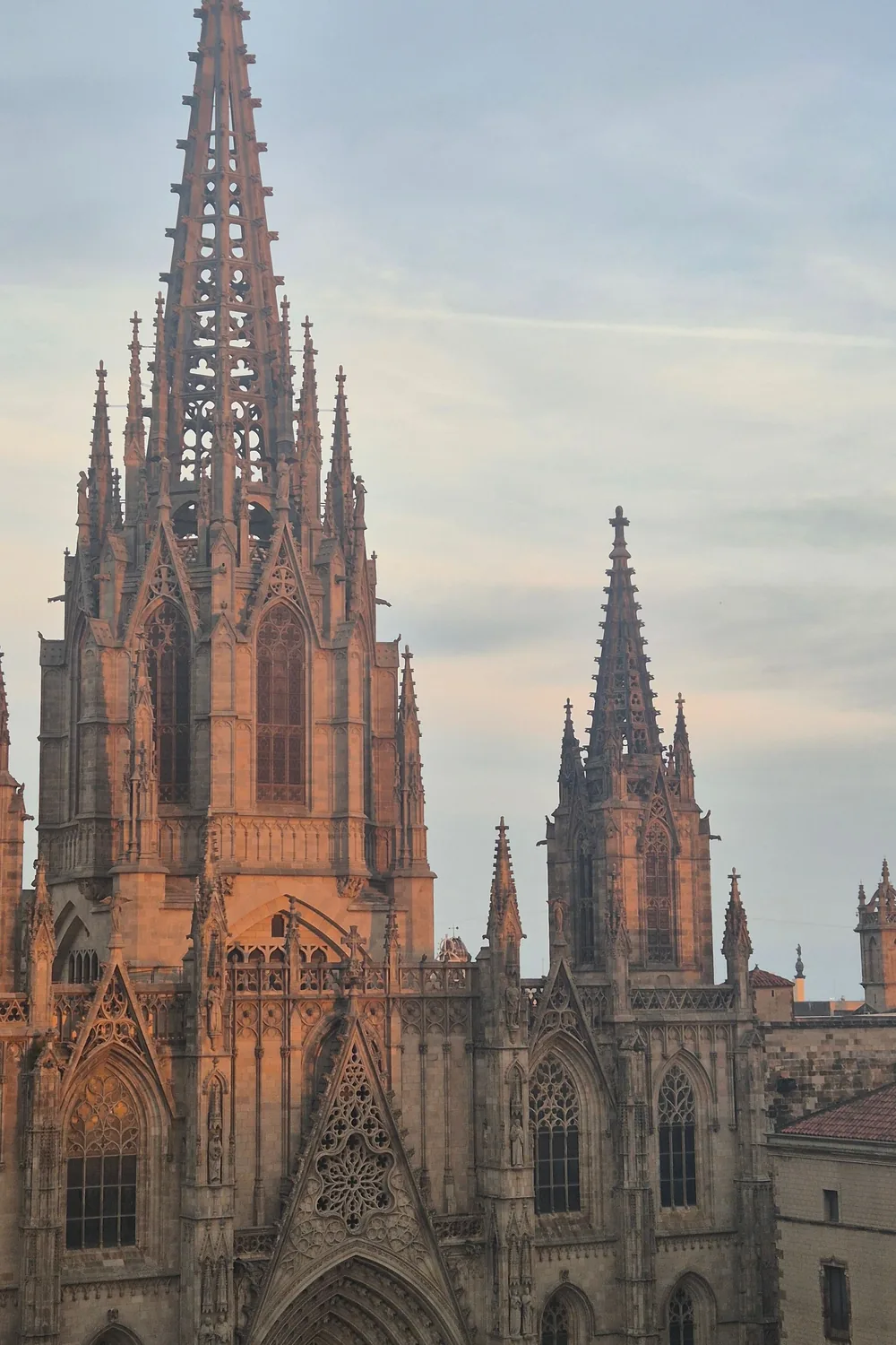 The gothic spires of Barcelona Cathedral warm in the last of the sunset light