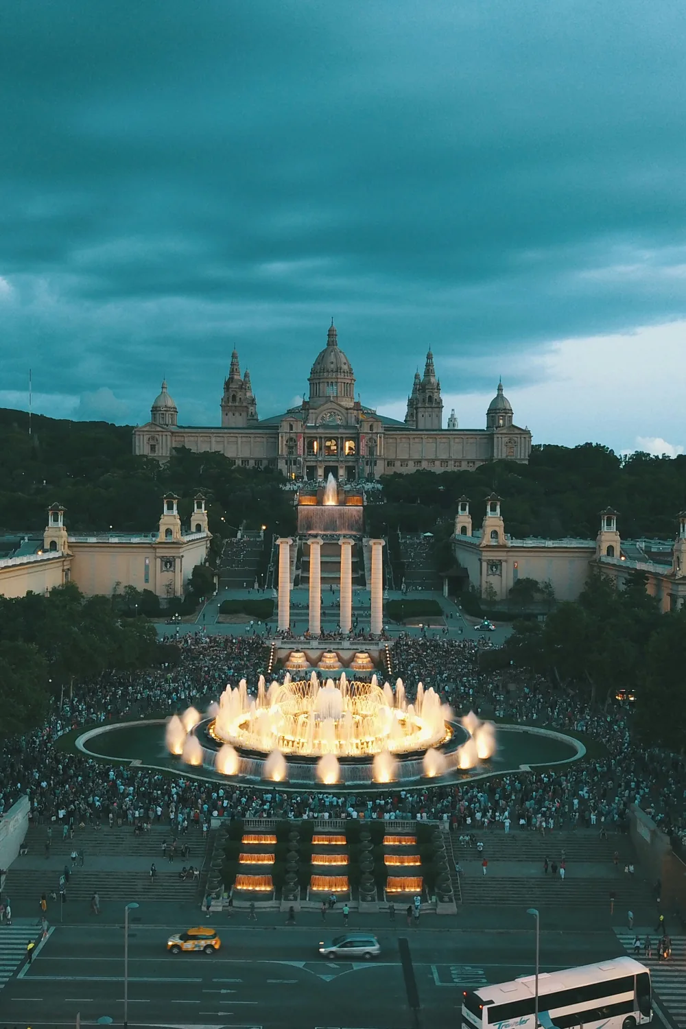 The Magic Fountain below Montjuïc lit gold at dusk, the Palau Nacional on the hill above it