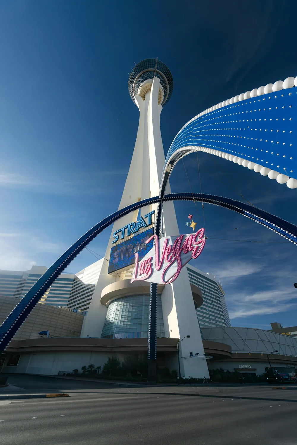 The STRAT tower rising above the north end of the Strip against a clear blue sky