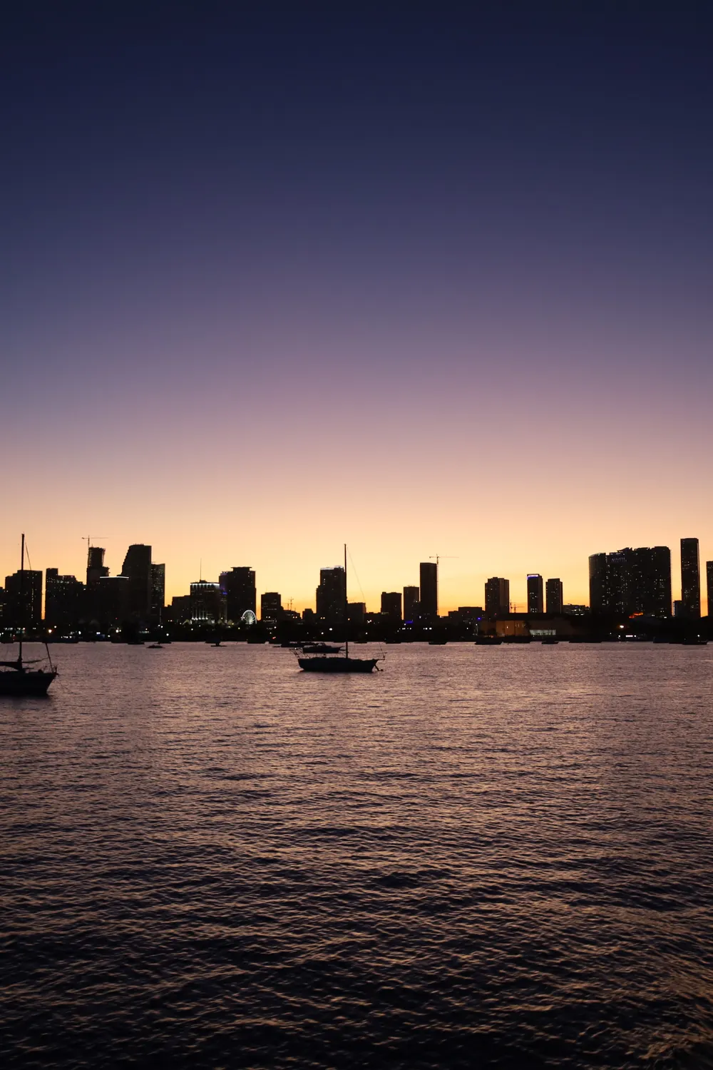 The Miami skyline at twilight with boats moored on Biscayne Bay