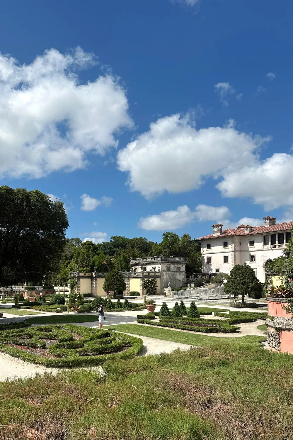 The formal Italianate parterre gardens of Vizcaya Museum and Gardens in Miami under a blue sky