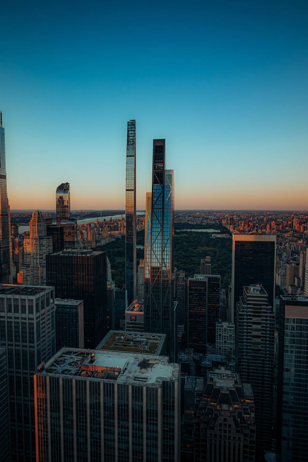 The Midtown Manhattan skyline at blue hour, its supertall towers rising above Central Park