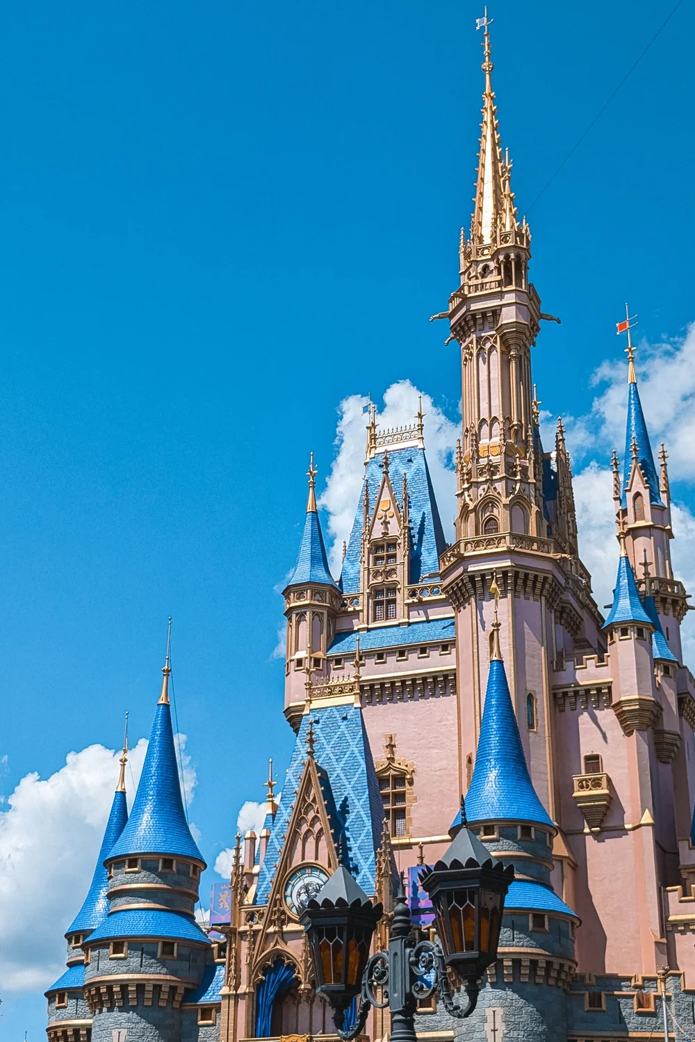 Cinderella Castle at Magic Kingdom, its blue turrets against a clear sky