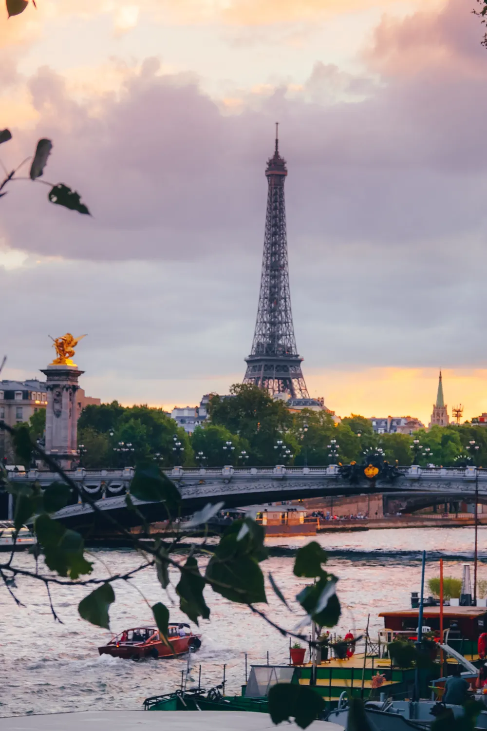 The Eiffel Tower above the Seine at sunset in Paris