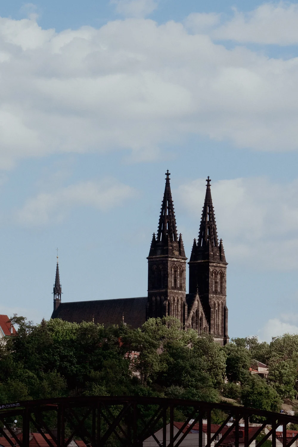 The twin neo-gothic spires of Vyšehrad's basilica on their bluff above the Vltava in Prague