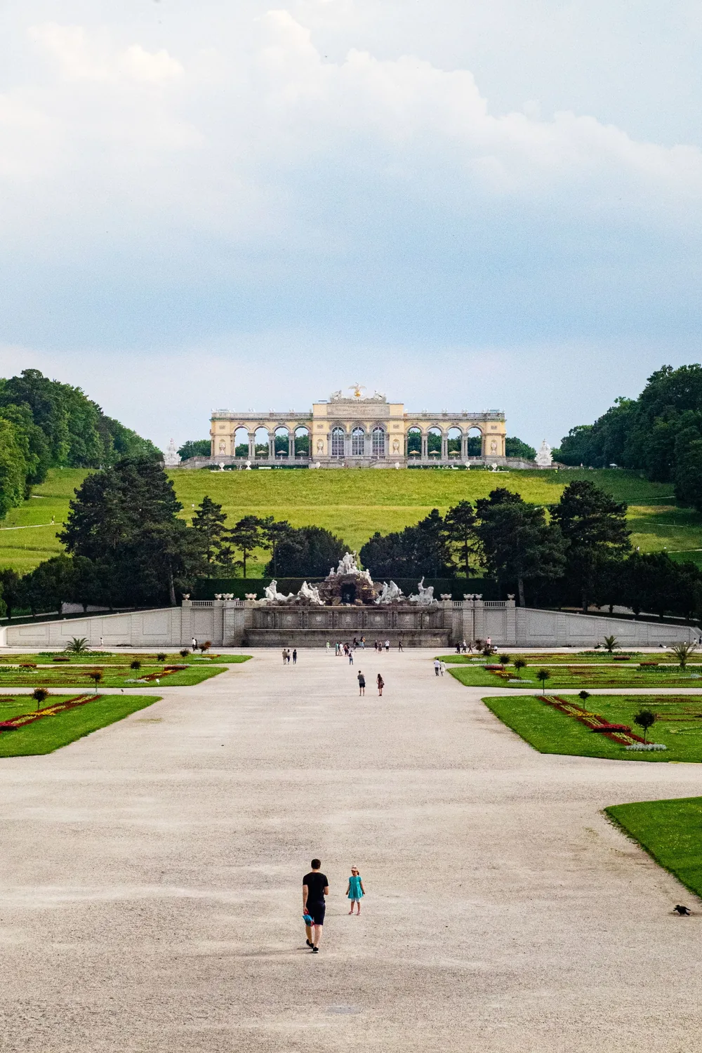 The avenue through the Schoenbrunn gardens rising to the Gloriette on the hill