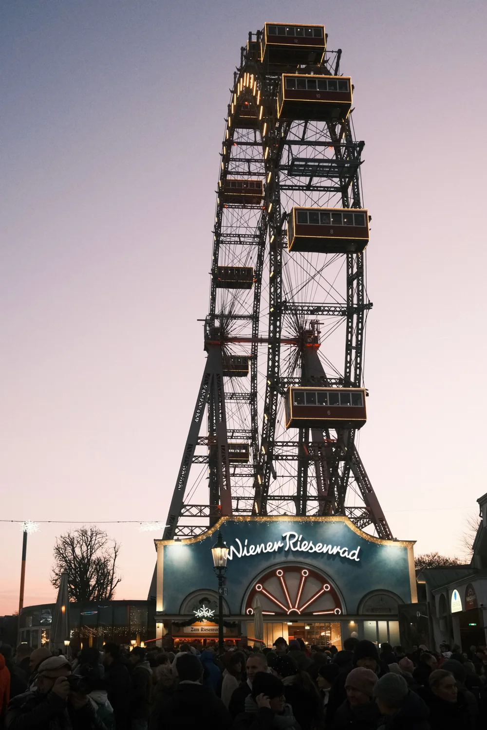The Riesenrad ferris wheel at the Prater lit against a sunset sky