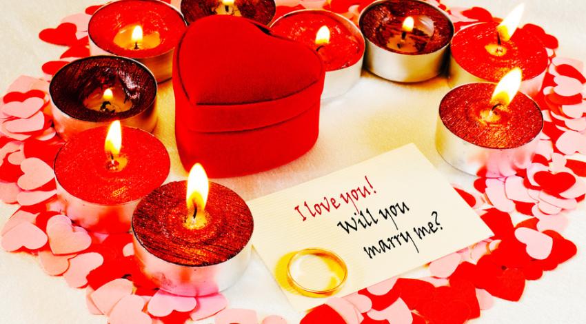 A candlelit room set up for a proposal at home