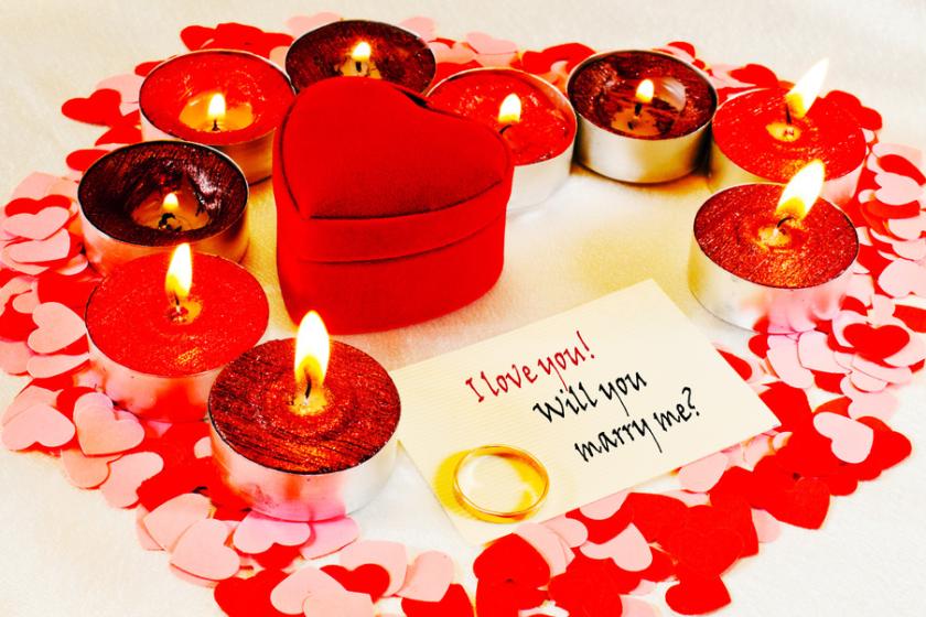 A candlelit room set up for a proposal at home