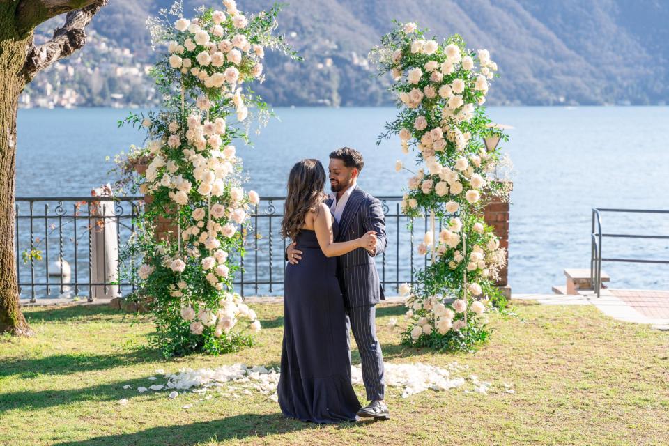Surprise marriage proposal beneath an elegant floral arch overlooking Lake Como, Italy