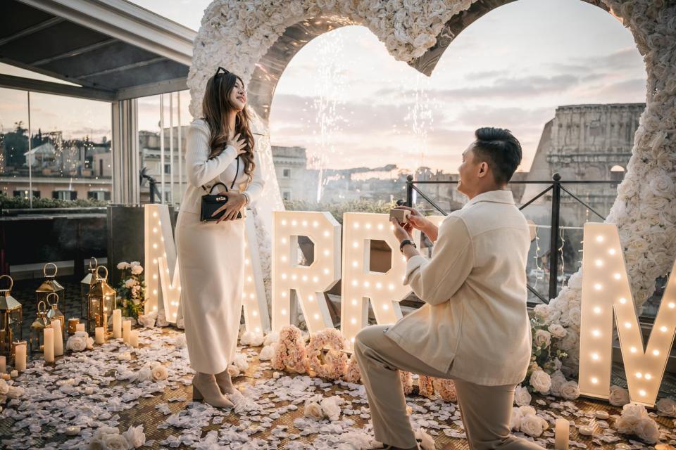 Romantic private dinner overlooking the Colosseum after a marriage proposal in Rome, Italy