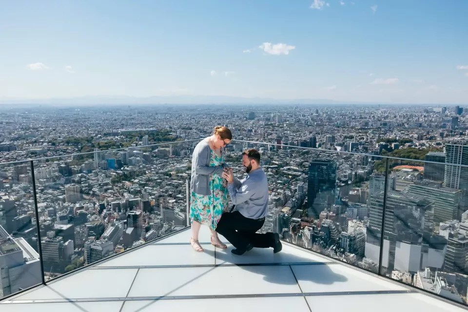 A proposal on a glass-edged rooftop high above Tokyo