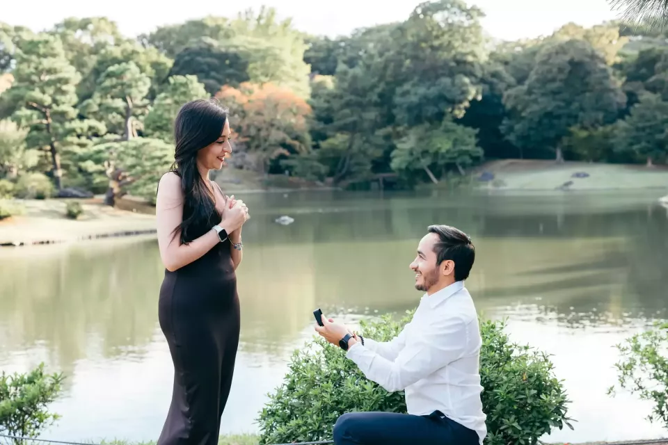 A proposal beside a pond in a Japanese garden