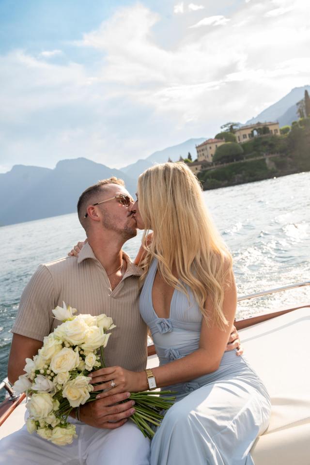 Newly engaged couple celebrating their Lake Como proposal during a romantic boat experience