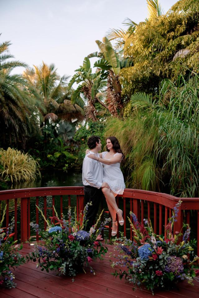 Couple embracing on a romantic flower-decorated pier in Miami