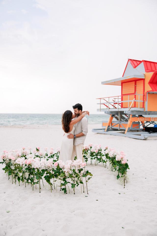 Couple celebrating near white floral décor on Miami Beach
