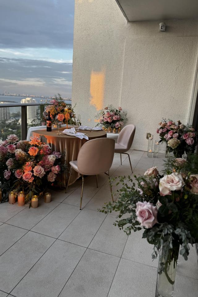 Luxury rooftop proposal décor with fresh flowers and Miami skyline views