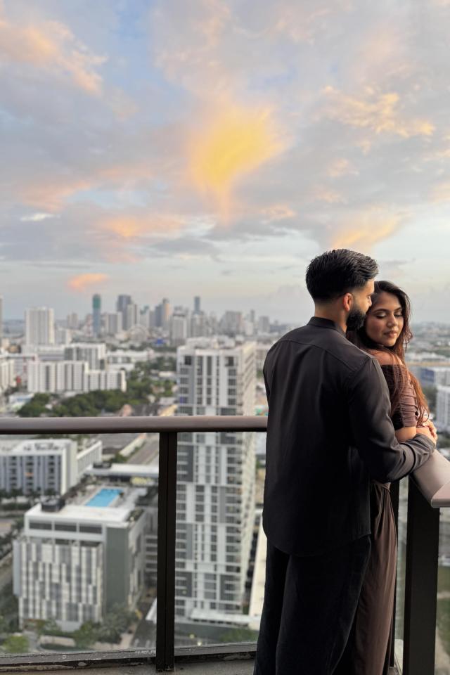 Couple overlooking the city during a rooftop proposal in Miami
