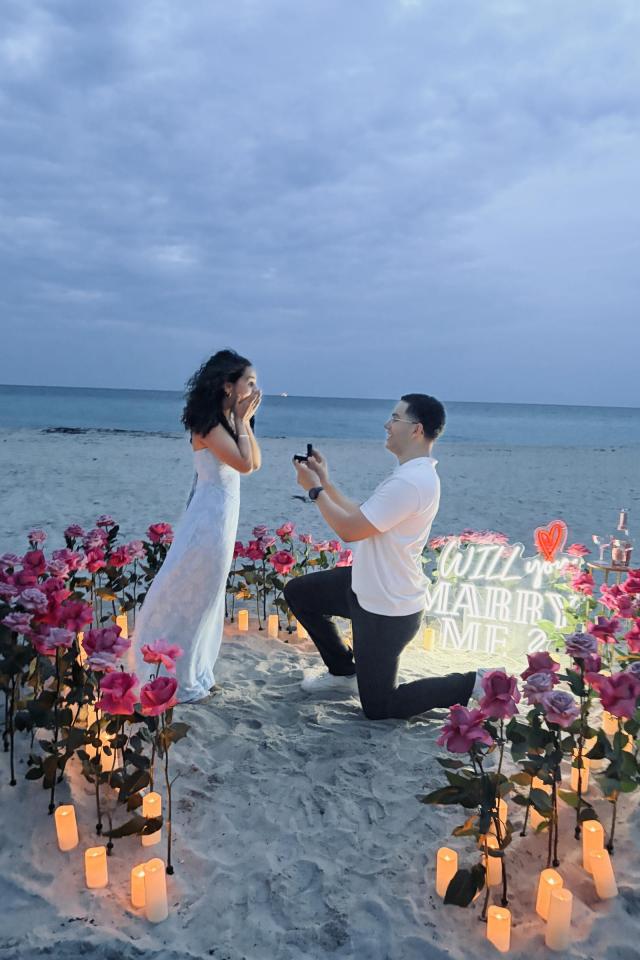 Man proposing within a colorful fresh-flower setup on Miami Beach