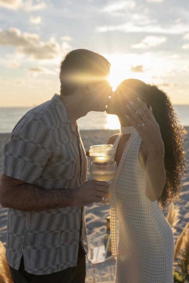 Couple kissing during a sunset proposal photoshoot on Miami Beach