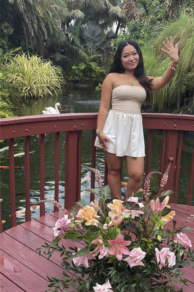 Woman standing on a flower-decorated garden pier in Miami