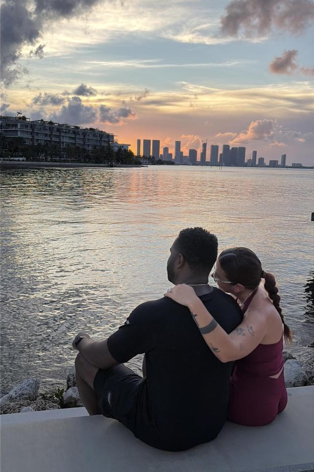 Couple overlooking the Miami skyline after a waterfront proposal