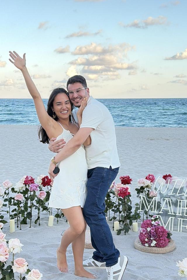 Newly engaged couple celebrating among fresh flowers on Miami Beach