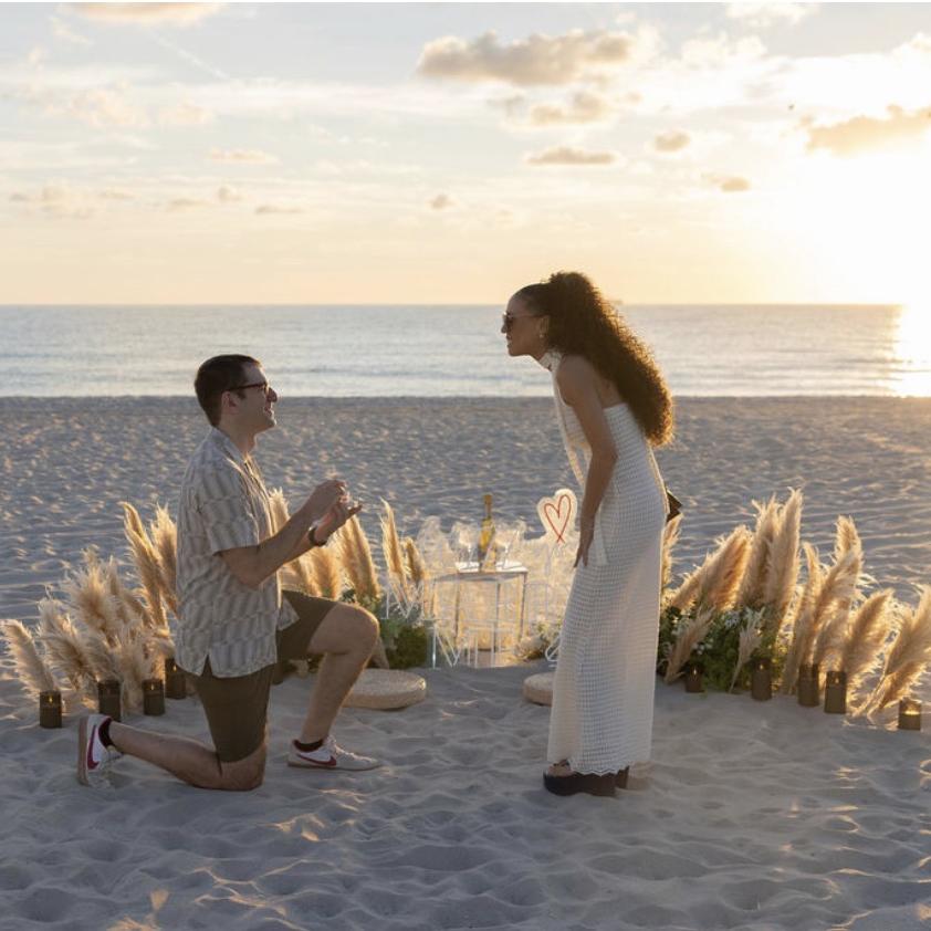 Sunset beach proposal with pampas grass décor in Miami