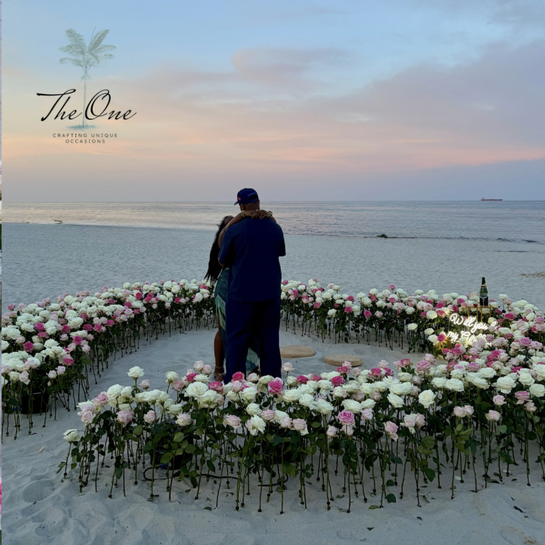 Man standing inside a large floral heart on Miami Beach
